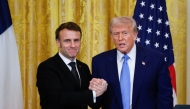 US President Donald Trump and French President Emmanuel Macron shake hands at the end of a joint press conference in the East Room to the White House in Washington, DC, on February 24, 2025. (Photo by Ludovic Marin / AFP)