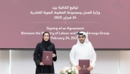 Shaikha Abdulrahman Al Badi, Assistant Undersecretary for National Manpower Affairs in the Private Sector at the Ministry of Labour, and Mohammed Abdullah Fakhroo, Vice-President of Nationalisation and Strategic Relations at Qatar Airways Group exchanging documents after signing the agreement.