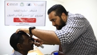 A medical practitioner attends to one of the patients.