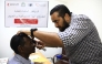 A medical practitioner attends to one of the patients.