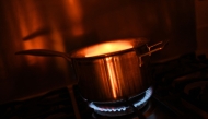 In this arranged photograph a pan is pictured on a gas hob in the kitchen of a residential property in Guildford, south of London on August 21, 2024. Photo by Justin TALLIS / AFP