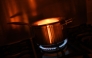 In this arranged photograph a pan is pictured on a gas hob in the kitchen of a residential property in Guildford, south of London on August 21, 2024. Photo by Justin TALLIS / AFP