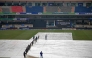 Groundmen cover the pitch as it rains before the start of the ICC Champions Trophy one-day international (ODI) cricket match between Australia and South Africa at the Rawalpindi Cricket Stadium in Rawalpindi on February 25, 2025. (Photo by Farooq NAEEM / AFP)
