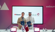 GCO Director and Chairman of the Permanent Web Summit Organizing Committee H E Sheikh Jassim bin Mansour bin Jabor Al Thani with iHeart official at the signing ceremony.