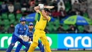 Australia's Travis Head (R) plays a shot during the ICC Champions Trophy one-day international (ODI) cricket match between Australia and Afghanistan at the Gaddafi Stadium in Lahore on February 28, 2025. (Photo by Aamir QURESHI / AFP)
