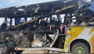 Handout picture released by Bolivian Police shows a man checking the wreckage of a bus that collided with another one on a highway near Uyuni, Bolivia on March 1, 2025. Photo by Handout / Bolivian Police / AFP