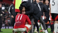 Manchester United's Dutch striker #11 Joshua Zirkzee is consoled by Manchester United's Portuguese head coach Ruben Amorim after missing the final penalty in the penalty shoot-out in the English FA Cup fifth round football match between Manchester United and Fulham at Old Trafford in Manchester, north west England, on March 2, 2025. (Photo by Darren Staples / AFP)