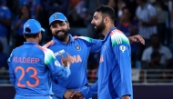 India's Varun Chakravarthy (R) celebrates with teammates after taking the wicket of New Zealand's captain Mitchell Santner during the ICC Champions Trophy one-day international (ODI) cricket match between New Zealand and India at the Dubai International Stadium in Dubai on March 2, 2025. (Photo by FADEL SENNA / AFP)
