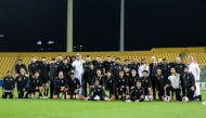 Al Sadd players and officials pose for a photograph at the Zabeel Stadium in Dubai.