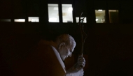 A picture taken at night shows the statue of John Paul II outside the Gemelli University Hospital where Pope Francis is hospitalized with pneumonia, in Rome on March 03, 2025. (Photo by Filippo MONTEFORTE / AFP)