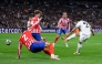 Real Madrid's Moroccan forward #21 Brahim Diaz (R) scores his team's second goal during the UEFA Champions League Round of 16 first leg football match between Real Madrid CF and Club Atletico de Madrid at the Santiago Bernabeu stadium in Madrid, on March 4, 2025. (Photo by Thomas COEX / AFP)
