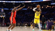 LeBron James #23 of the Los Angeles Lakers shoots a 3-point basket to score his 50,002 NBA regular season and playoff career points during the first half against Zion Williamson #1 of the New Orleans Pelicans at Crypto.com Arena on March 04, 2025 in Los Angeles, California. Ronald Martinez/Getty Images/AFP 
 