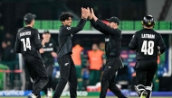 New Zealand's Rachin Ravindra (second left) celebrates with teammates after taking a catch to dismiss South Africa's Aiden Markram during the ICC Champions Trophy one-day international (ODI) semi-final cricket match between New Zealand and South Africa at the Gaddafi Stadium in Lahore on March 5, 2025. (Photo by Asif Hassan / AFP)
