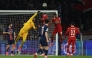 Liverpool's Brazilian goalkeeper #01 Alisson (2L) punches the ball as he makes a save during the UEFA Champions League Round of 16 first leg football match between Paris Saint-Germain (FRA) and Liverpool (ENG) at the Parc des Princes stadium in Paris on March 5, 2025. (Photo by Anne-Christine POUJOULAT / AFP)
