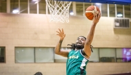 Al Ahli's Raekwon Deshawn Rogers leaps to score.