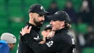 New Zealand's Daryl Mitchell (L) and Nathan Smith celebrate their team's win at the end of the ICC Champions Trophy one-day international (ODI) semi-final cricket match between New Zealand and South Africa at the Gaddafi Stadium in Lahore on March 5, 2025. (Photo by Asif Hassan / AFP)
 