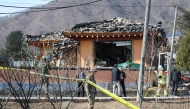 South Korean soldiers and rescue workers inspect a damaged house after a bomb accident at a village in Pocheon on March 6, 2025. (Photo by YONHAP / AFP) 