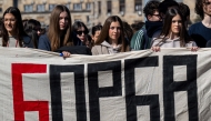 Demonstrators hold a banner reading 'Struggle' as students, pupils and citizens block a street in front of the National Assembly building in Belgrade, on March 4, 2025, standing in silence to pay tribute to the 15 victims of the tragedy at Novi Sad railway station in November 2024. Photo by Andrej ISAKOVIC / AFP