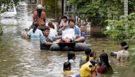 People wade through flood water after heavy rain and overflow of Siak River in Pekanbaru, Riau province, Indonesia, March 6, 2025. (Photo by Hadly Vavaldi/Xinhua)
