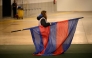 A staff member takes away the FC Barcelona's flag following the decision to cancel the Spanish league football match between FC Barcelona and CA Osasuna at Estadi Olimpic Lluis Companys in Barcelona on March 8, 2025. (Photo by Josep LAGO / AFP)
