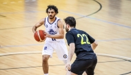 Al Khor's Youssef A Y Yagoub (left) prepares to make a pass.