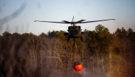 A rescue helicopter picks up water at Wild Wood Lake on March 8, 2025 in Westhampton, New York. Photo by Andrew Theodorakis / GETTY IMAGES NORTH AMERICA / Getty Images via AFP