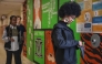 Eighth-grader Ja’ Nae Dorsey (R) unlocks her cell phone pouch after school followed by her twin sister La’ Mae Dorsey (L) and 7th-grader Hayden Jones (C) at Mark Twain Middle School in Alexandria, Virginia, on March 6, 2025. Photo by Jim WATSON / AFP