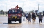 People is transported on a police boat through flooded waters the day after a heavy storm in Bahia Blanca, 600 km south of Buenos Aires on March 8, 2025. At least ten people died and more than 1,000 were evacuated in the Argentine port city of Bahia Blanca as torrential rains flooded homes and hospitals, destroyed roads and forced authorities to cut the power. (Photo by PABLO PRESTI / AFP)
