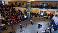 An audience member (C-L) asks a question to the Prime Minister of Greenland and Inuit Ataqatigii (IA) party candidate Mute Bourup Egede and other candidates during a televised all party political debate at the high school, in the capital Nuuk on March 8, 2025. (Photo by Odd ANDERSEN / AFP)
 