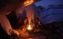 Palestinians gather around a fire to keep warm in Jabalia in the northern Gaza Strip on March 10, 2025. (Photo by Omar Al-Qattaa / AFP)