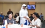 A QNB official distributing gift to a patient during the Ramadan Iftar.