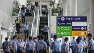 Policemen gather as they wait for the arrival of former Philippine president Rodrigo Duterte at Ninoy Aquino International Airport in Pasay, metro Manila on March 11, 2025. (Photo by Jam Sta Rosa / AFP)