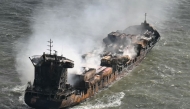 Smoke rises from the MV Solong cargo ship in the North Sea, off the coast of Withernsea, east of England, on March 11, 2025, after it collided with the MV Stena Immaculate tanker on March 10. Photo by Paul ELLIS / AFP