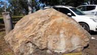 This undated handout photo released on March 12, 2025 shows a boulder sitting outside a school containing dinosaur footprints, in the town of Biloela. (Photo by Handout / University of Queensland / AFP) 