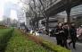 The CCTV Headquarters building (L) is seen as pedestrians walk along the Central Business District (CBD) in Beijing on March 11, 2025. (Photo by ADEK BERRY / AFP)