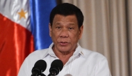 (FILES) Philippine President Rodrigo Duterte delivers his speech during the presentation ceremony of the signed document on the Organic Law for Bangsamoro Autonomous Region of Muslim Mindanao to officials of the Moro Islamic Liberation Front (MILF) at Malacanang palace in Manila on August 6, 2018. (Photo by TED ALJIBE / AFP)
