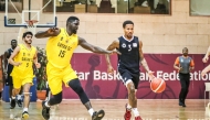 Al Sadd's J’von Joseph Mc Cormick (right) dribbles to the basket.