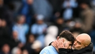 Manchester City's Spanish manager Pep Guardiola (R) kisses Manchester City's Croatian defender #24 Josko Gvardiol (L) at the end of the English Premier League football match between Manchester City and Brighton and Hove Albion at the Etihad Stadium in Manchester, north west England, on March 15, 2025.(Photo by Oli SCARFF / AFP)