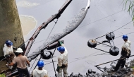 Workers of Petroecuador work on the cleaning of an oil spill at the Viche River in the province of Esmeraldas, Ecuador on March 15, 2025. Photo by Julio Galarza / AFP