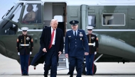 US President Donald Trump walks to board Air Force One at Joint Base Andrews in Maryland on March 14, 2025. Trump is spending the weekend at his Florida Mar-a-Lago resort. (Photo by Brendan SMIALOWSKI / AFP)
