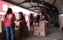 A handout picture provided by Syria's Kurdish Red Crescent shows members of the emergency charity group preparing humaintarian aid boxes, in the northeastern city of Qamishli on March 16, 2025. (Photo by Kurdish Red Crescent / AFP) 