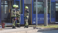 Fire fighters stand near a tram in Gera on March 16, 2025. Photo by Bodo Schackow / dpa / AFP