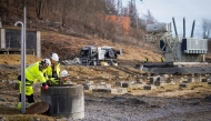 Representatives from a private company assisting with environmental consulting take water samples after several tons of oil leaked out in Baerum near Oslo, Norway, on March 17, 2025 following a break-in and damage to the Hamang transformer station this weekend. Photo by Ole Berg-Rusten / NTB / AFP