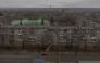 A car drives past residential buildings damaged by air attacks, in Kostyantynivka, eastern Donetsk region, on March 17, 2025, amid the Russian invasion of Ukraine. (Photo by Roman Pilipey / AFP)