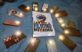 Filipino migrant workers turn on their phone flashlights and place them in a circle around a clenched fist symbol to express support for former Philippine president Rodrigo Duterte, at Repulse Bay in Hong Kong on March 16, 2025. (Photo by Purple Romero / AFP)