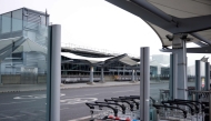 A photograph taken on March 21, 2025 shows trolleys lined up at the empty arrival area outside Terminal 5 of Heathrow airport following its closure after a fire broke out at a substation supplying power of the airport, in Hayes, west London. Photo by BENJAMIN CREMEL / AFP