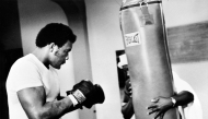 US Heavyweight boxer George Foreman (L) is seen on January 1973 during a training session in preparation for his match against Joe Frazier in Kingston. (Photo by AFP)