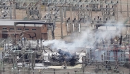 An aerial photograph taken on March 21, 2025 shows smoke billowing from a substation supplying power to Heathrow Airport amid efforts to douse the remainder of the flames after a fire broke out in Hayes, west London. (Photo by AFP)
 