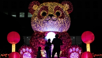 People stand in front of an illuminated giant panda decoration in celebration of the upcoming Lunar New Year in Jakarta, Indonesia, on Jan. 24, 2025. (Xinhua/Veri Sanovri)
