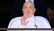 Pope Francis waves from a window of the Gemelli hospital before being discharged following a five weeks hospitalization for pneumonia, in Rome on March 23, 2025. Photo by Filippo MONTEFORTE / AFP